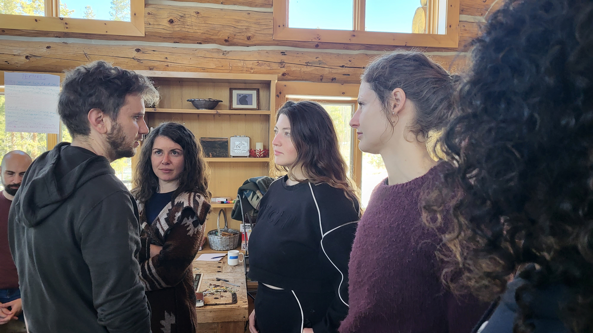Participants in intimate face-to-face group dialogue inside the retreat lodge
